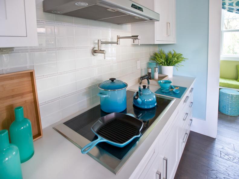 Kitchen Range With White Cabinets, Tile Backsplash and Blue Pots