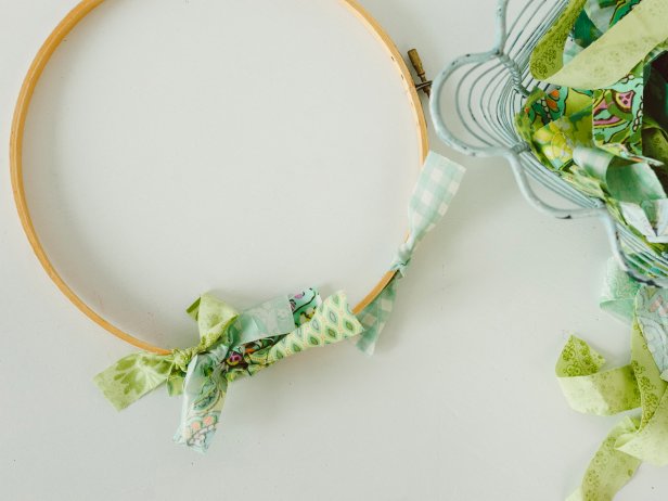 Separate the embroidery hoop's inner and outer rings — only one ring is needed for this project. Simply knot fabric strips one at a time around the ring. Pack the knots together as close as possible so none of the hoop is visible.