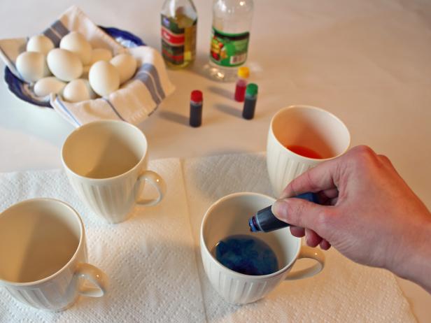 Adding food coloring to Easter egg dye bath