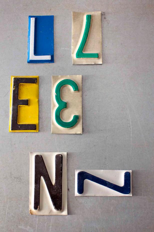 Decide what letters to use. Keep in mind that E’s, N’s and L’s can be difficult to find so you may need to substitute 3’s, Z’s and 7’s. Turn a 3 backward to create the look of an E. Lay a Z on its side to make an N. Turn a 7 upside down to make an L