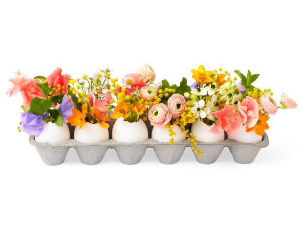 A dozen egg shells filled with delicate flowers as an Easter decoration.