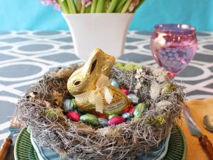Easter table setting with handmade bird's nest and candy