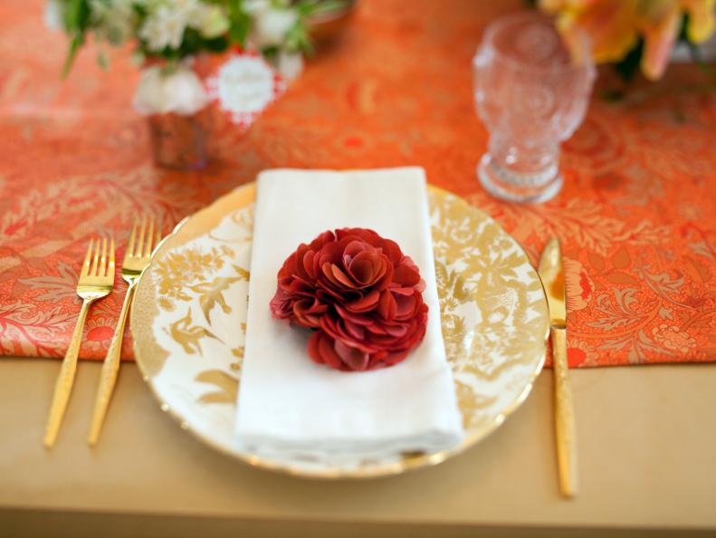 Place Setting With Gold & White Plate, Red Flower and Gold Flatware