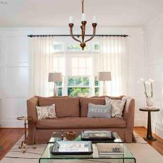 White Transitional Living Room With Tan Sofa and Bronze Chandelier