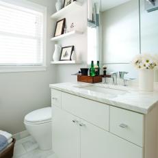 Small, White Bathroom With Floating Shelves and Contemporary Vanity