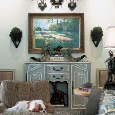 Traditional Gray Living Room With Antique Cabinet and Antlers