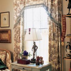 Victorian Bedroom with Patterned Window Treatment and Antique Blue Accent Table 