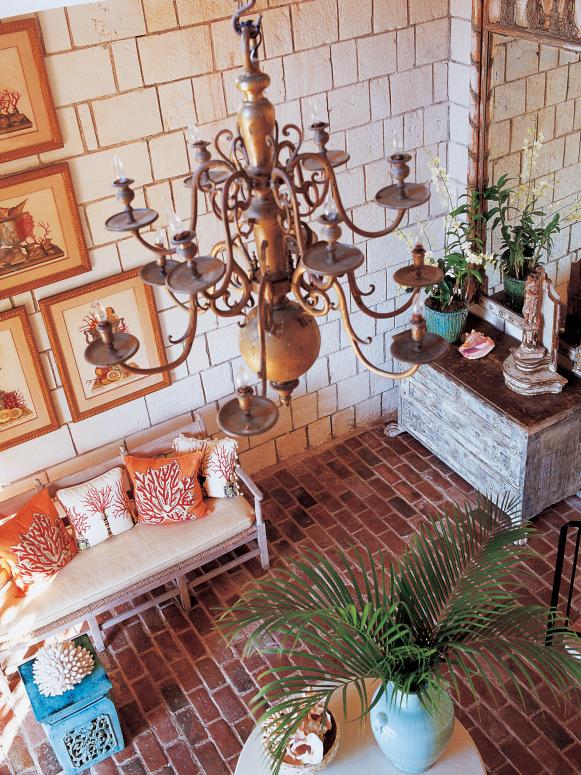 Neutral Entryway With Brick Floor and Antique Chandelier 