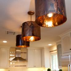 White Kitchen With Copper Light Fixtures