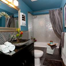 Bathroom with Blue Painted Walls and Black Granite Sink
