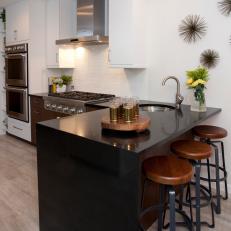 Kitchen With Black Quartz Countertop and Wood Barstools