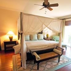 Neutral Bedroom With Four Poster Bed and Woven Bench