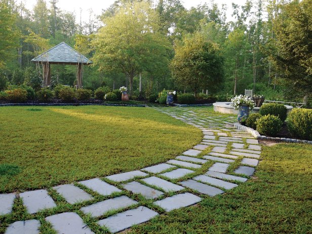 Curved Stone Walkway Leading to Garden and Small Arbor