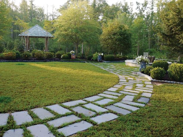 Curved Stone Walkway Leading to Garden and Small Arbor