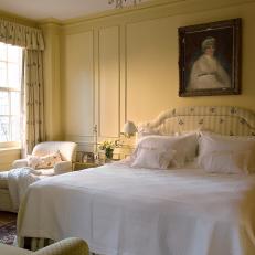 Yellow French Country Bedroom With Antique Art
