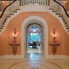 Pink Foyer With Sweeping Staircase