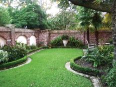 Lawn Surrounded by Brick Wall and Boxwoods