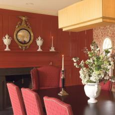 Dramatic Dining Room With Fiery Red Fireplace and Damask Wallpaper