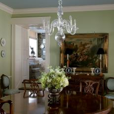 Green Dining Room With Ghost Chandelier and Round Table 