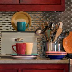 Stainless Steel Backsplash & Red Kitchen Cabinets