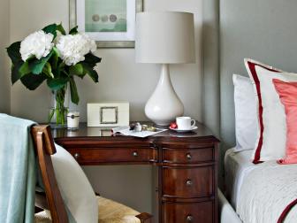 Bedroom With Desk as Nightstand and Gray Headboard