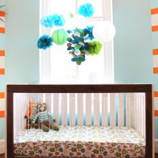 Mod Brown Crib Topped by Blue and Green Mobile