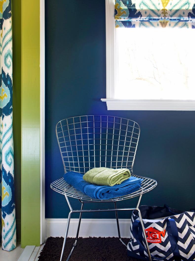 Blue and Green Towels Laid on See-Though Chair in Small Bathroom