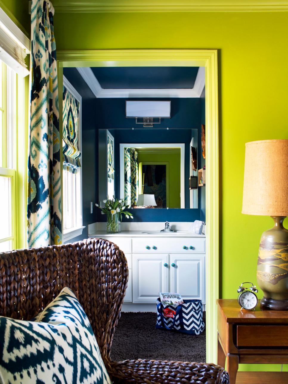 Bold Navy Bathroom With White Vanity and Patterned Roman Shade 