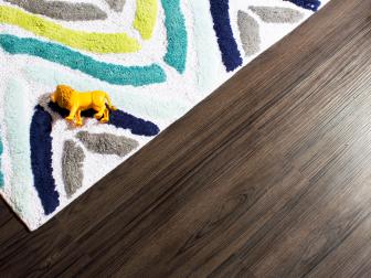 Brown Plank Floor With White and Blue Rug