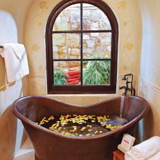 Mediterranean-Style Bathroom With Copper Soaking Tub