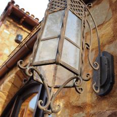 Stone Home Exterior With Old World Metal Sconce