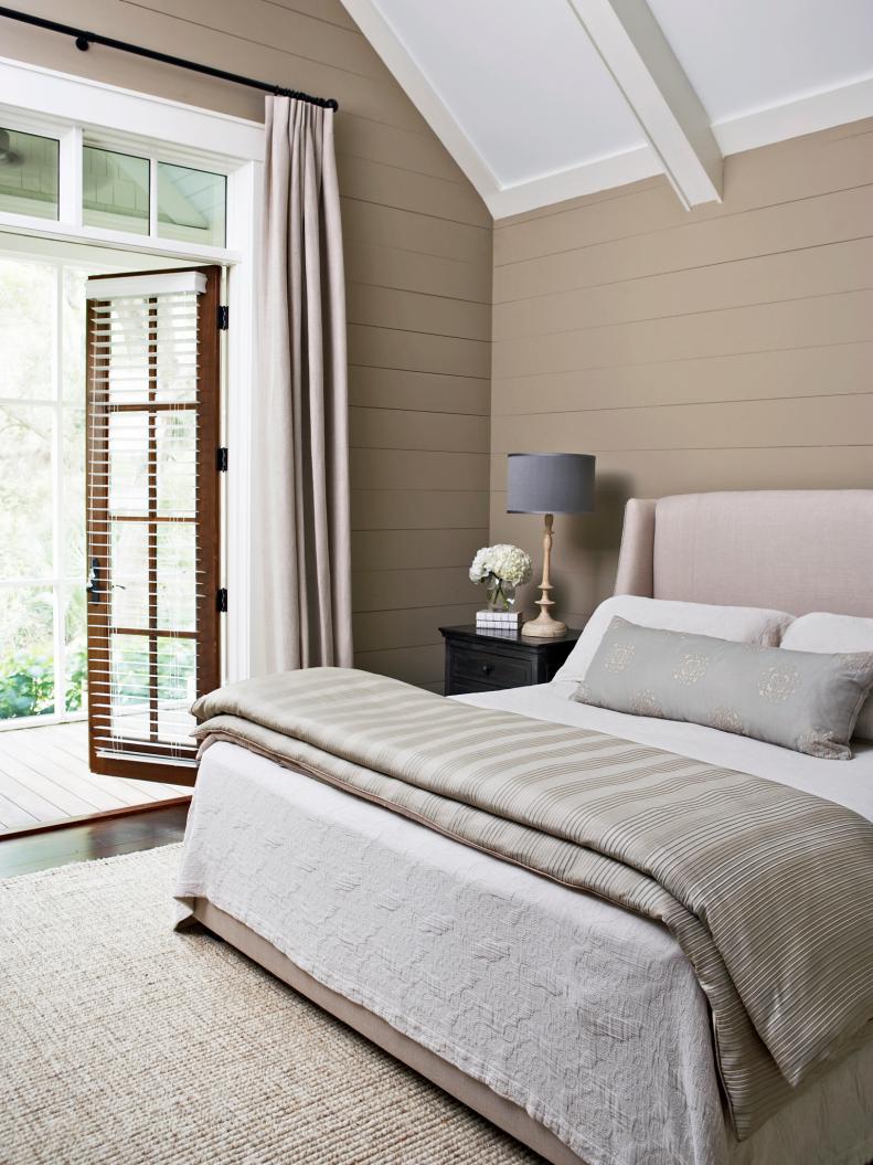 Small Neutral Bedroom with French Door and wall paneling