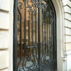 Ornate Iron Gate With Wooden Doors
