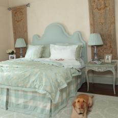 Master Bedroom With Ornate Blue Headboard