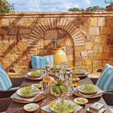 Outdoor Dining Area And Decorative Yellow Stone Wall