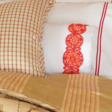 Neutral Patterned Bedding With Applique Pillow
