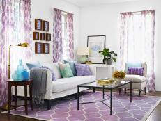 Purple Curtains, Rug and Pillows in a White Living Room