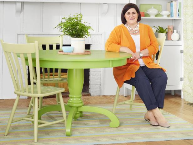 Woman sits at green dining table