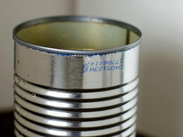 Wash cans thoroughly and allow to dry. Use rubbing alcohol to remove any ink that has been stamped on the cans