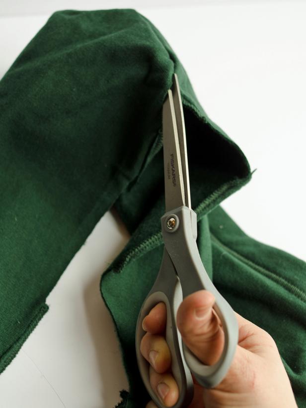 Use a sharp pair of scissors to cut up back center of sweatshirt until peak of the hood.