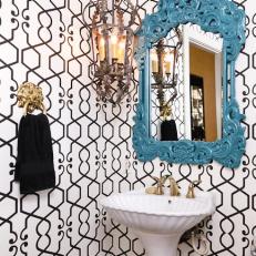 Eclectic Bathroom with Patterned Wallpaper and Bold Mirror 