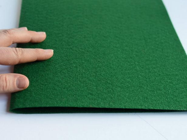 Fold piece of stiff green felt in half width-wise.