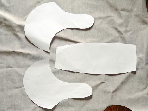 Make a paper template for hat to fit your child's head. You'll need: one center piece shaped like a rectangle with slightly curved sides and two pieces for the sides with ear flaps. It may take a few tries to get the sizing and shape right. Be sure to leave enough room for seam allowances. Once the template comfortably fits your child's head, place the paper pieces on the back side of faux leather fabric and trace with a permanent marker.