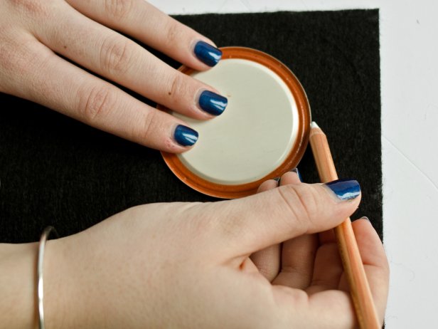 Trace around a circular object, such as a lid, soup can or drinking glass, with chalk pencil onto black felt