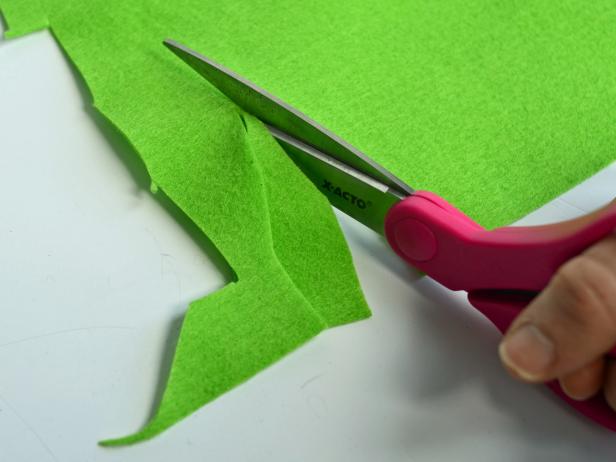 With sharp scissors, cut pointed leaf shapes out of three different shades of felt to cover one or both sides of bag.