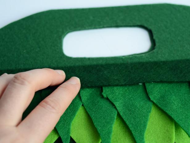 Continue layering leaves until bag is covered. Lastly, glue felt strip on top to create a clean top edge. Allow glue to fully dry before use.