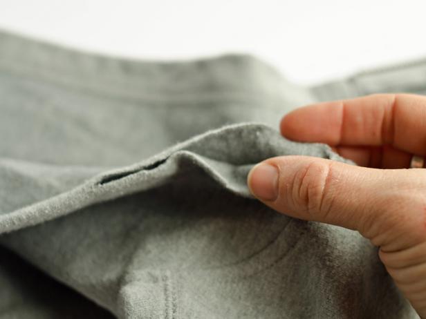 Cut on center of fold around hood's hem. If hoodie has a drawstring, remove it