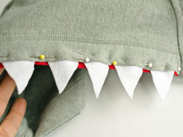 When pinning felt teeth into the hoodie, allow red strips to slightly overlap behind a tooth when one ends and another begins.