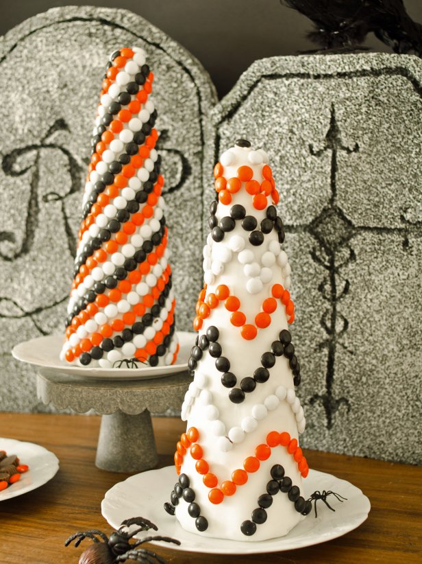 Cover inexpensive foam topiary forms with fondant and candy to create a sweet Halloween decoration or centerpiece that kids will love helping to craft.