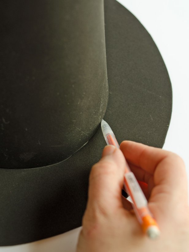 To create a brim for a witch's hat, Step 5B is to set the cone on top of the circle and center it. Trace around base of cone with a pencil. (This is done after you have traced around a dinner plate with a pencil on the second piece of foam and cut out the circle for this brim shape.)